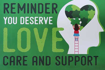 Green background poster with the text "Reminder you deserve love care and support" with a graphic